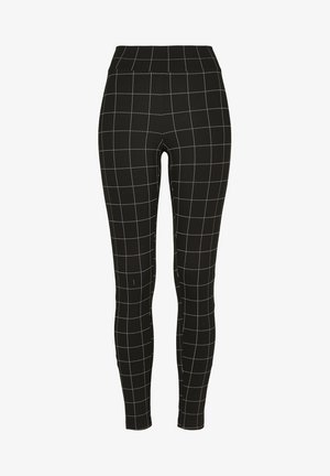 Leggings neri con un design aderente, caratterizzati da un motivo a griglia bianca, vita elastica e una texture di tessuto liscia e elasticizzata.