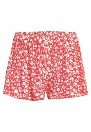 Red floral shorts featuring an elastic waistband, made of lightweight fabric with a scattered white flower pattern throughout.