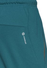 adidas Performance BADGE OF SPORT - Jogginghose - legtea
