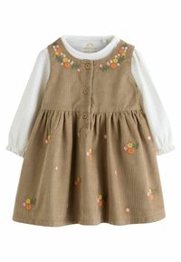 Bruine corduroy jurk met een uitlopende rok en bloemborduurwerk. Heeft een witte blouse met lange mouwen, met stippen en houten knopen.