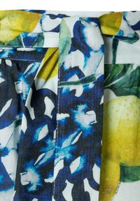 Floral and lemon print fabric with a stitched belt loop, featuring blue, green, yellow, and white colors on cotton material.