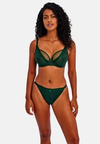 Ensemble de lingerie verte comprenant un soutien-gorge en dentelle à motif avec armatures et un slip taille haute assorti. Tissu texturé avec un design géométrique.