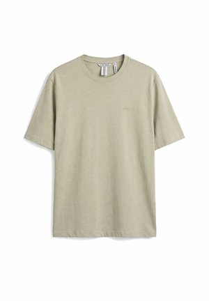 Maglietta di cotone beige chiaro a maniche corte con collo rotondo, piccolo logo ricamato sul petto e etichetta con il marchio all'interno del colletto.