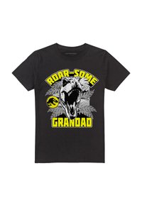 Black cotton T-shirt featuring a graphic design of a roaring dinosaur with the texts "ROAR-SOME GRANDAD" in yellow, surrounded by green foliage.