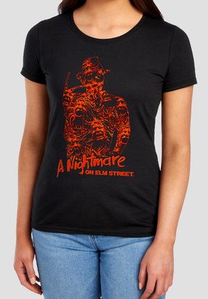 Black t-shirt with orange graphic of a distorted figure holding a clawed hand, text "A Nightmare on Elm Street" below.