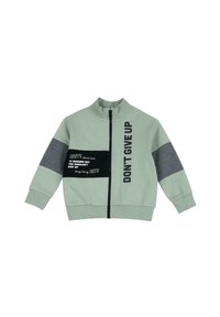 Grön zip-up jacka med hög krage; har grå paneler och textdetaljer, inklusive "DON'T GIVE UP" och en svart patch med vit text.