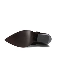 Black suede high-heeled shoe with a pointed toe and textured sole, featuring a smooth, dark brown plastic heel.