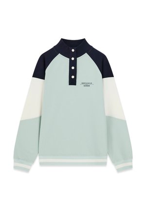 Light blue, white, and navy long-sleeve pullover with buttoned high collar and "North Sails Guess" logo on chest.