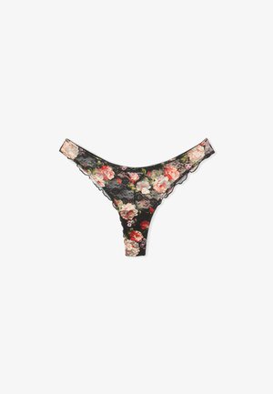 Thong en dentelle noire avec un motif floral en rose, rouge et vert. Présente des bords festonnés et une texture douce. Détail de design élégant tout au long.