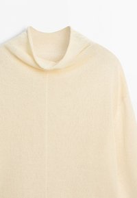 Cream-colored knit sweater with a loose turtleneck collar and long sleeves, displayed against a white background.