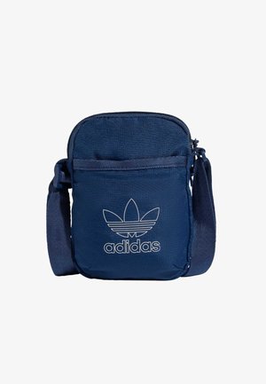 Mornarskoplavi platneni crossbody torba s patentnim zatvaračem, s bijelim Adidas logom, podesivim remenom i prednjim džepom.