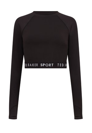 Czarny długi rękaw crop top wykonany z elastycznej tkaniny z okrągłym dekoltem. Posiada kontrastowy biały pasek z logo wzdłuż dołu.