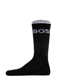 Black cotton sock with ribbed top featuring white "BOSS" lettering. Smooth texture and fitted shape.