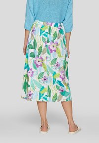 Floral skirt features a white base with green leaves and purple flowers, knee-length, elastic waistband, cotton material, and lightweight fabric.
