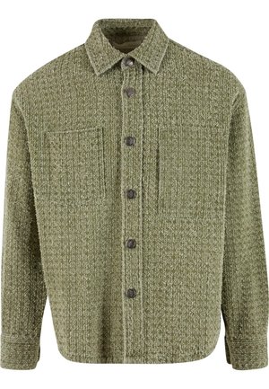 Green textured shacket with a button-down front, two chest pockets, and a collar. Features dark buttons and a relaxed fit.
