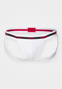 Weißer Herren-Thong mit einem breiten elastischen Bund und rot-schwarzem "HUGO"-Branding. Hergestellt aus einem glatten, dehnbaren Stoff.