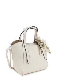 Cream-colored textured leather handbag with dual handles, black trim, detachable strap, and a patterned silk scarf tied to one handle.