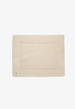 Cream-colored rectangular pet mat with a soft, textured surface and a stitched border. Features a small label in one corner.