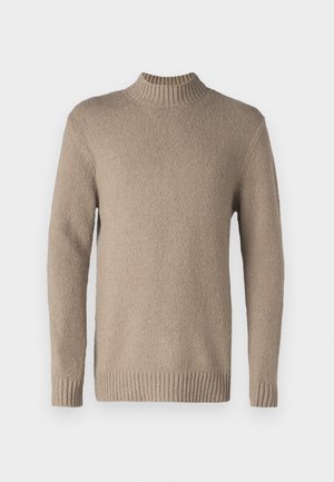 Beige kötött pulóver, textúrált felülettel, bordás nyakkal és mandzsettával. Hosszú ujjakkal és egyenes aljjal rendelkezik, klasszikus dizájnnal.