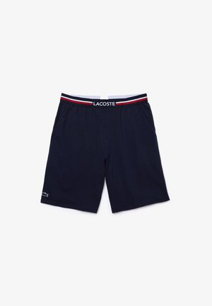 Marineblauwe shorts van zachte stof, met een elastische tailleband met rode en witte strepen en een klein wit logo op het been.