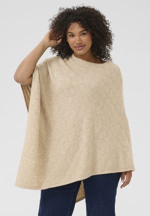 Poncho en tricot beige avec un motif à carreaux texturé, design ample et ourlet tombant sous les hanches. Matériau doux et confortable.