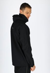 Black waterproof jacket featuring a hood, elastic cuffs, and a zippered front. Logo detail on the back. Simple, functional design.