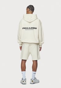 Pegador Jersey con capucha - beige