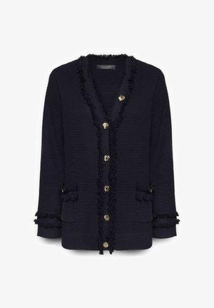 Zwarte gebreide cardigan met V-hals, gouden knopen aan de voorkant, franjerand en twee voorzakken met gefranjerde kleppen.