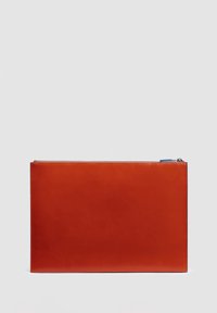 Bolsa rectangular de cuero rojo con textura suave, cierre de cremallera en la parte superior y una pequeña pestaña azul en la cremallera.