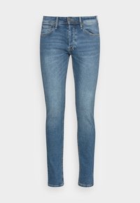 Skinny fit jeans in lichtblauwe denim. Klassiek vijf-pocket ontwerp met stiksels. Gladde textuur, medium was met subtiele vervaging.