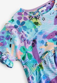 Children's short-sleeve dress with multicolored floral and star patterns in shades of purple, blue, green, and peach, featuring a ruffled sleeve edge.