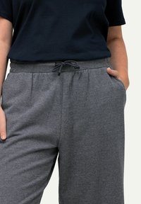 Pantalones grises con estampado, con cintura elástica y cierre de cordón, que cuentan con bolsillos laterales y una tela texturizada.