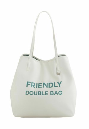Weiße Tragetasche aus strukturiertem Material mit der Aufschrift "FRIENDLY DOUBLE BAG" in fetten, türkisfarbenen Buchstaben. Zwei Tragriemen zum Tragen.