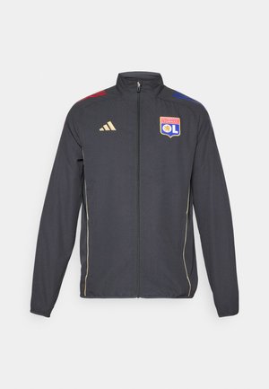Black athletic jacket with gold accents, featuring a full zipper, high collar, and blue and red horizontal stripes on shoulders. Olympic Lyonnais logo.