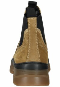 Braune Wildleder-Ankle-Boots mit elastischen Seitenpartien, einem glatten schwarzen Besatz und einer strukturierten Gummisohle für guten Halt.