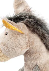 Plush donkey toy with light beige fur, gray accents, yellow ear with white polka dots, and black synthetic hair on the head.