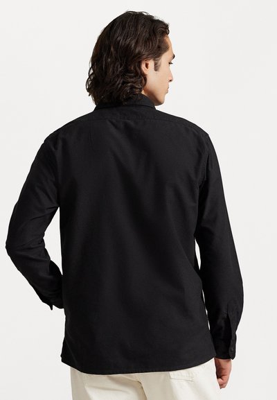 Black button-up shirt with a tailored cut, long sleeves, collar, and smooth cotton texture. Features a plain back without embellishments.