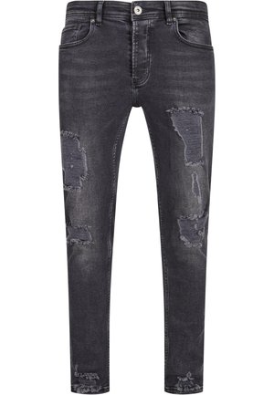 Donkergrijze skinny jeans van denim, met versleten details en rafelige patches aan de voorkant. Standaard vijf-pocket stijl met een knoopsluiting.