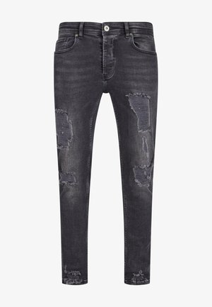 Tummanharmaat kapeat farkut, joissa on kulutettuja yksityiskohtia ja revittyjä alueita edessä. Perinteinen viisi taskua -tyyli nappikiinnityksellä.