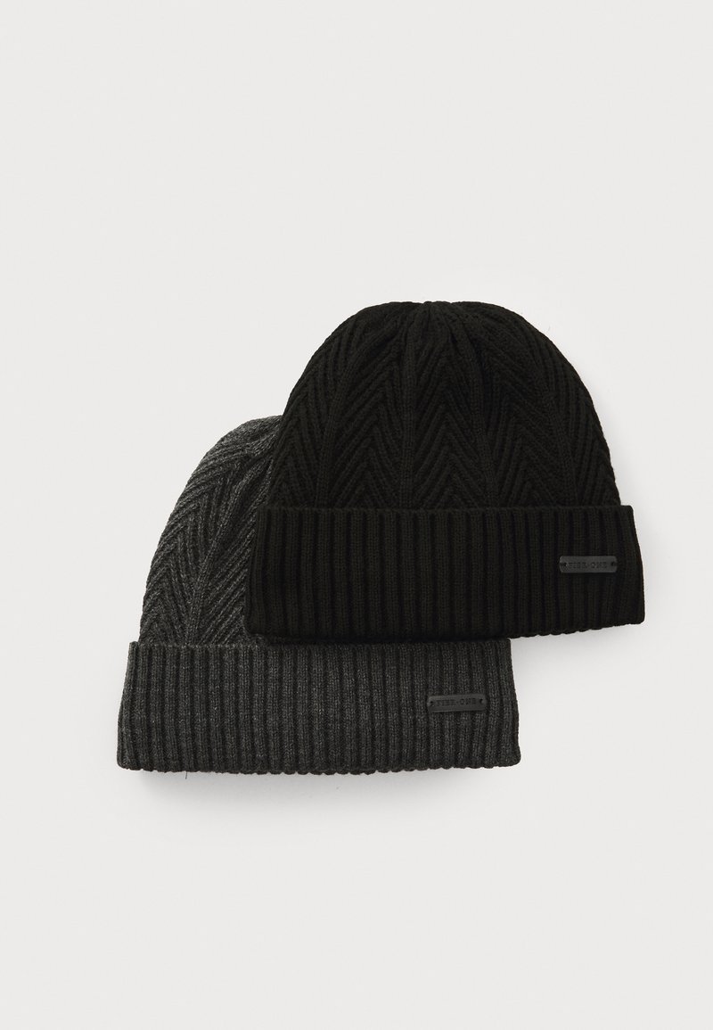 Two knitted beanies: one black with a ribbed texture and fold-over cuff, the other dark gray with a herringbone pattern and ribbed band.