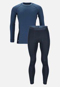 Navy blue thermal top with long sleeves and ribbed texture, paired with matching ribbed thermal leggings featuring branded waistband.