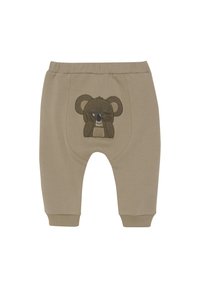 Beige Baumwollhosen mit einem gestickten Bärenmotiv auf der Vorderseite, einem elastischen Bund und umgenähten Knöcheln.