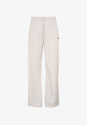 White striped pants with a relaxed fit and elastic waistband, featuring vertical lines in a darker shade, made from lightweight fabric.