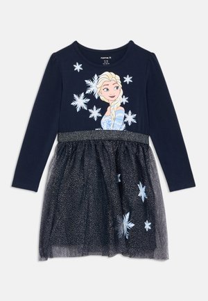 Mornarska haljina dugih rukava s glitter pojasom, koja ima grafiku lika i uzorke pahulja na prozirnoj suknji.