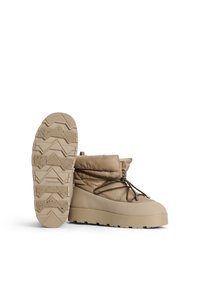 Beige, wattierte Knöchelstiefel mit Gummisohle, die über ein strukturiertes Profil, verstellbare Schnürsenkel und ein gestepptes Obermaterial zur Isolierung verfügen.