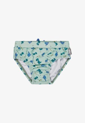 Light green toddler swim briefs with blue and teal dinosaur prints and small fabric dinosaur spikes on the waistband.