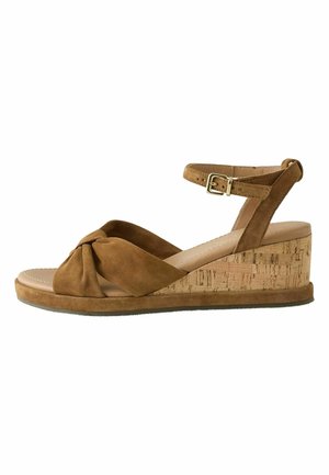 Pruun seemis kiilkingaga sandaal korkkontsaga, sõlmega eesmine rihm, pahkluu pealne rihm ja kuldne pandlaga kinnis.