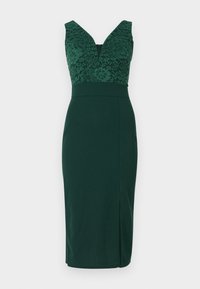 Robe moulante verte avec corsage en dentelle, décolleté en V, sans manches et une fente à l'avant pour un détail supplémentaire.