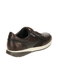 Zapatilla de cuero marrón con acabado texturizado, suela de goma crema, cierre de cremallera en el lateral y una etiqueta de marca cerca del talón.