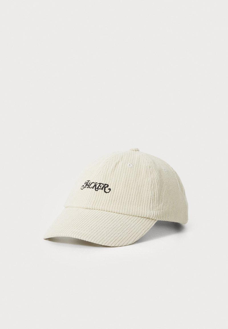 Cream-colored corduroy cap featuring a curved brim and embroidered "HACKER" text in black on the front. Smooth texture and ribbed pattern.